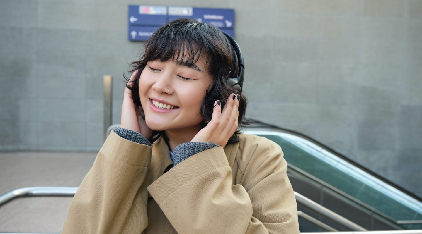 portrait-of-happy-woman-korean-girl-in-headphones-listening-music-in-headphones-enjoying-sound.jpg